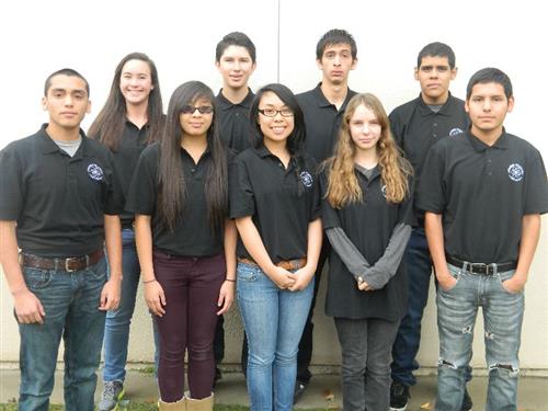 Nine academic decathlon students wearing their acadeca black polo 